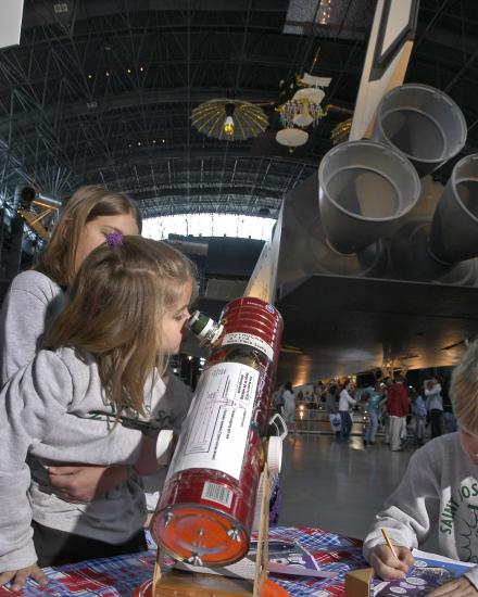 Girl Looks through Telescope at Udvar-Hazy Center