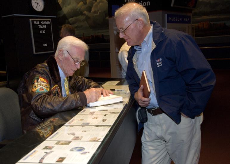 Astronaut Gene Cernan Signs an Autograph