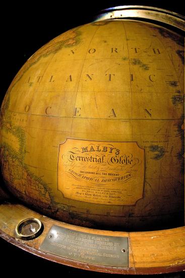 View of nineteenth-century wooden globe focusing on branding below markings indicating North Atlantic Ocean