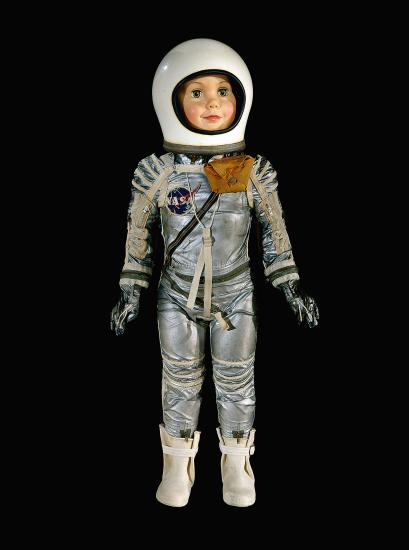 Child-size doll in silver spacesuit with white helmet and white rubber boots