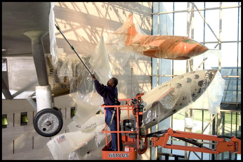 Brenda Averett protecting aircraft in the Boeing Milestones of Flight Hall