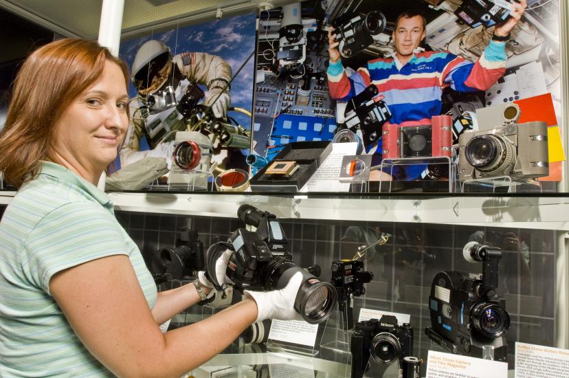 Museum Specialist installing the Space Camera Exhibit Case