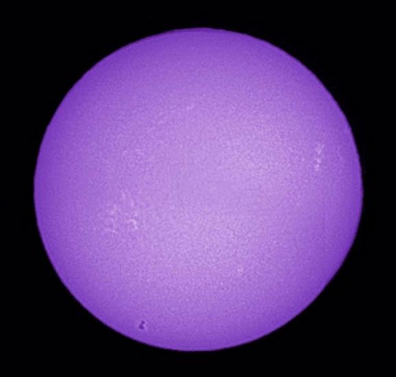 A view of the Sun using a telescope that provides purple images.