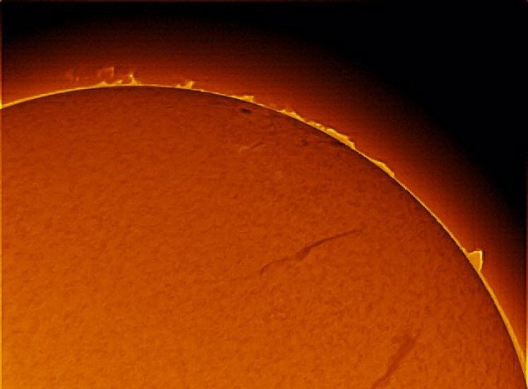 A part of the sun with prominences of plasma floating above the sphere