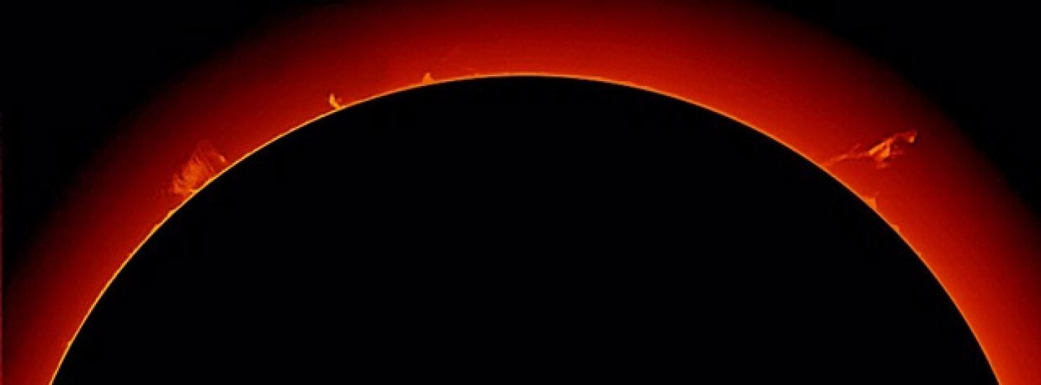 View of multiple large prominences of plasma floating away from the Sun.