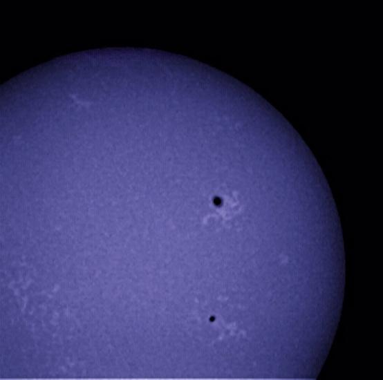 View of the chromosphere of the sun with an emphasis on multiple sunspots.