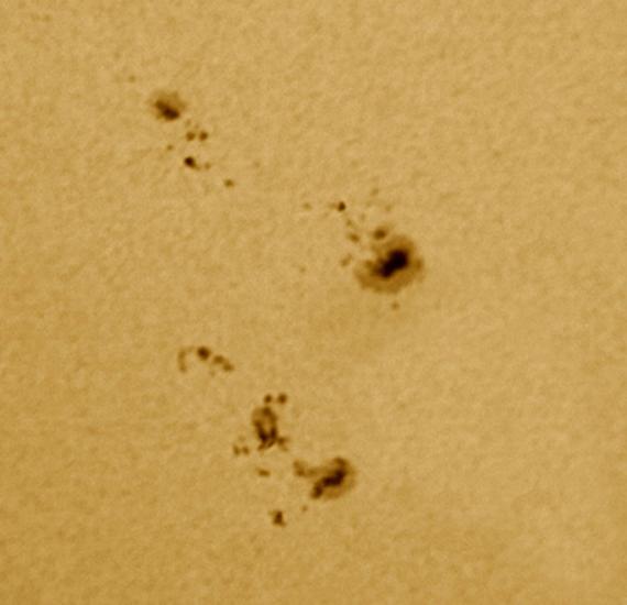 A close-up view of two groups of sunspots on the Sun.