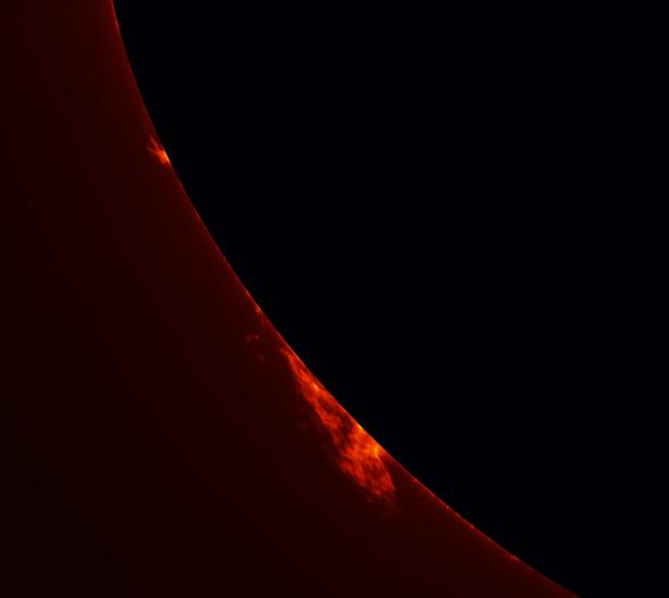 Partial view of the Sun's surface with an emphasis on two prominences floating away from the surface of the Sun.