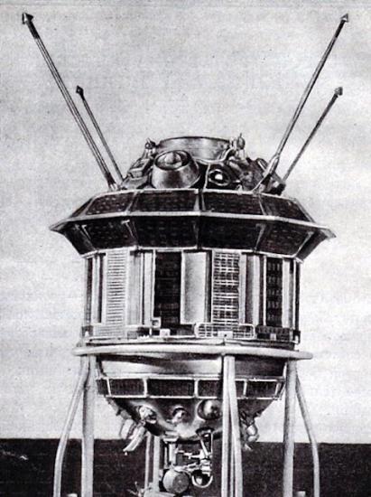 A spacecraft with a cylinder base shape and multiple antennae and other objects attached.