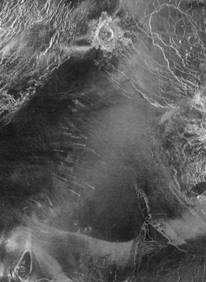 A black and white satellite view of dunes made from loose materials.