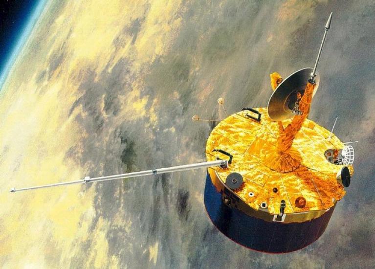 An artist's depiction of a cylinder-shaped orbiter with a satellite and multiple antennae orbiting over Venus.