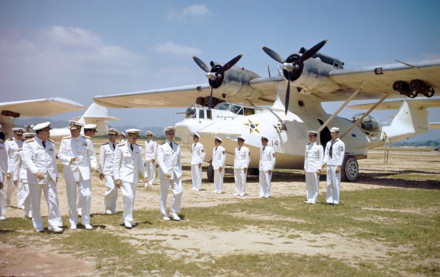 U.S. Navy officers review a line of Brazilian PBY-5A amphibians with senior Brazilian naval aviators