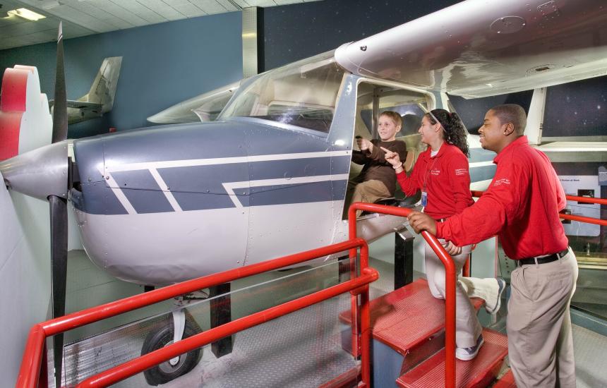 Explainers Assist a Young Visitor in the How Things Fly