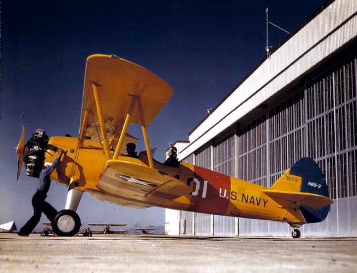 Historic airplane in front of hangar