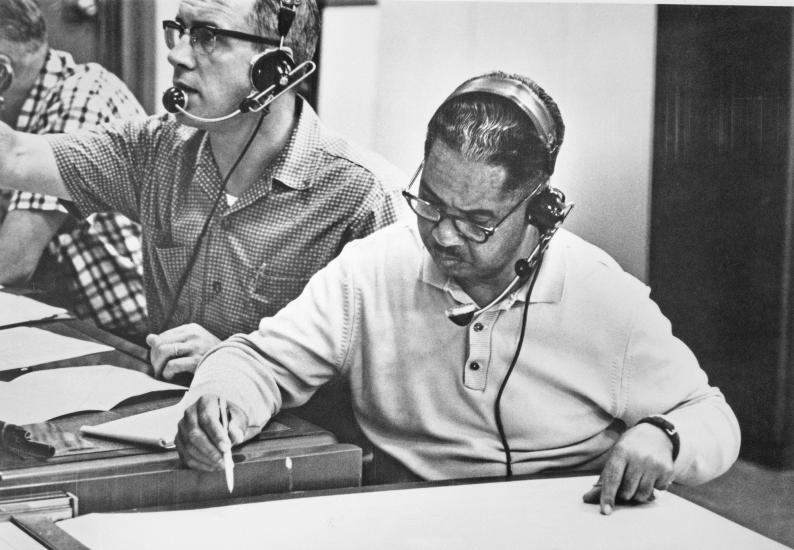 Vance H. Marchbanks Jr., an African-American male flight surgeon, looks at medical charts during the "Friendship 7" mission.