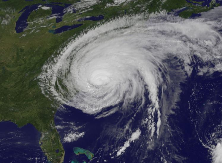 Satellite view of Hurricane Irene, a large tropical cyclone in the Atlantic basin, as seen after landfall in North Carolina. The hurricane's outer bands stretch towards the New England region.