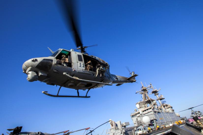 The bottom view of a helicopter taking off. 