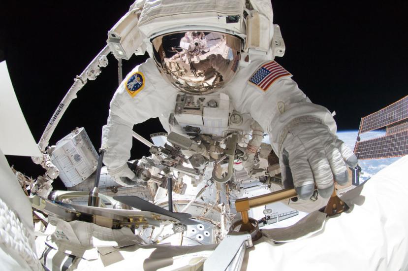 Greg Chamitoff, a NASA astronaut, performs a spacewalk outside the International Space Station in his spacesuit. 