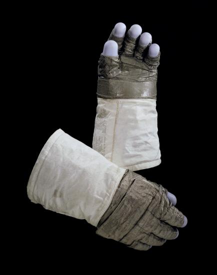 Pair of lunar gloves used on Apollo 11 mission. A special gray fabric makes up most of the gloves with the blue fingertips made from silicon rubber.