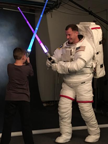 Nick Hague, class of 2013 astronaut, tweeted this photo of himself being “ambushed” by his son during an official NASA photo shoot