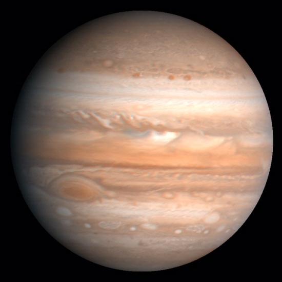 A view of Jupiter, an orange and tan gas planet