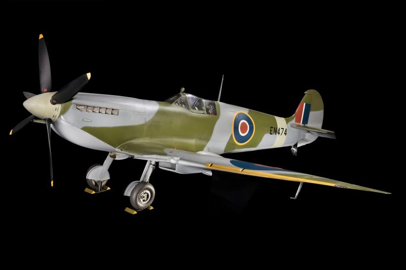 Overall, three-qaurter side view of green and blue Spitfire aircraft