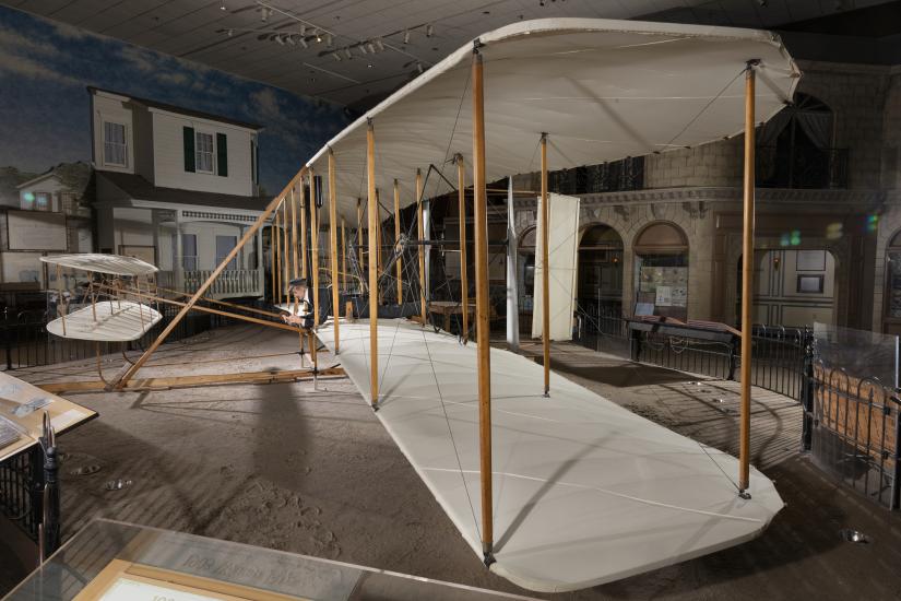 Side of wood, fabric, and metal canard biplane 1903 Wright Flyer in museum