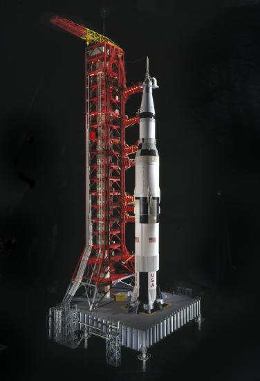 Scale model of black and white Saturn V Rocket with launch pad