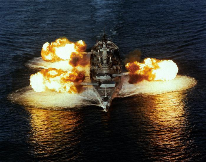 Battleship with guns firing on each side. 