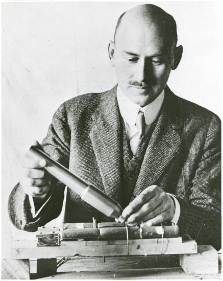 A man with balding hair works on creating an early version of the rocket