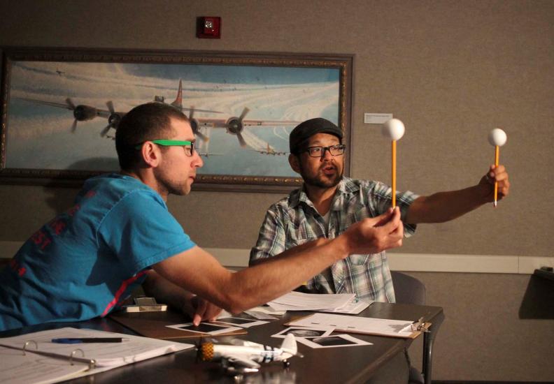 Two middle school science teachers explore a Moon phase activity during the STEM Institute for Educators at the Museum in 2016.