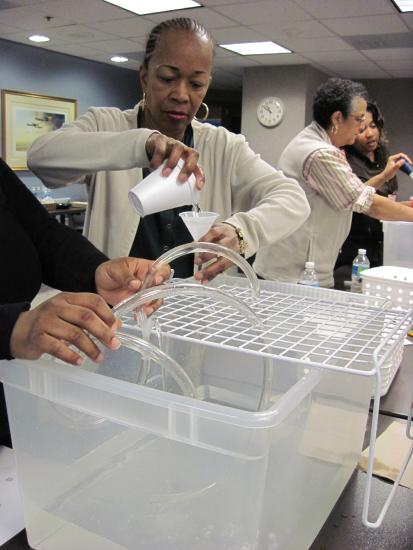 Teachers pour liquid between containers.