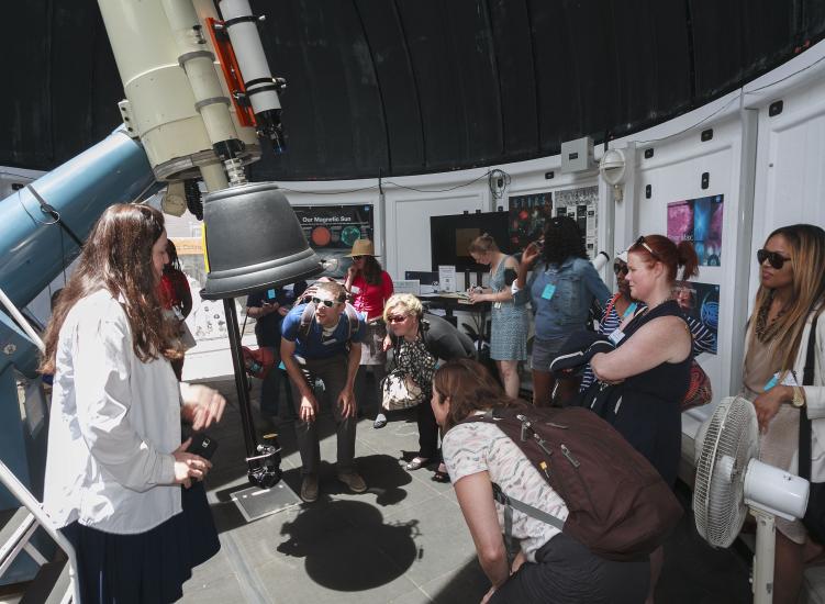 teachers look through telescope