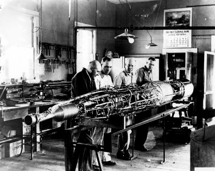 Robert Goddard works on a rocket with his team. 