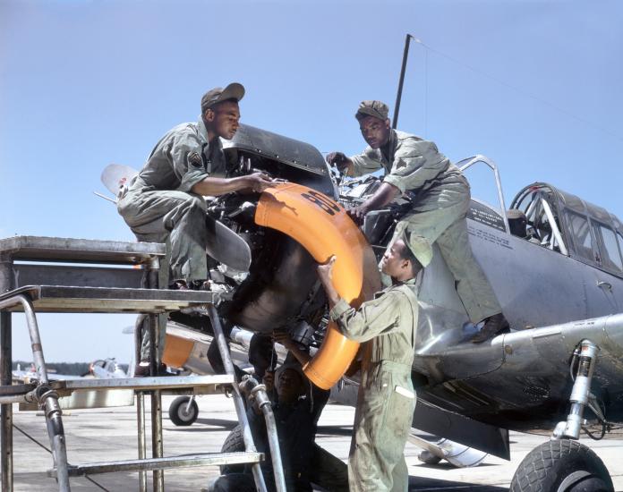 Mechanics at Tuskegee Army Air Field maintain an engine of a Vultee BT-13A Valiant