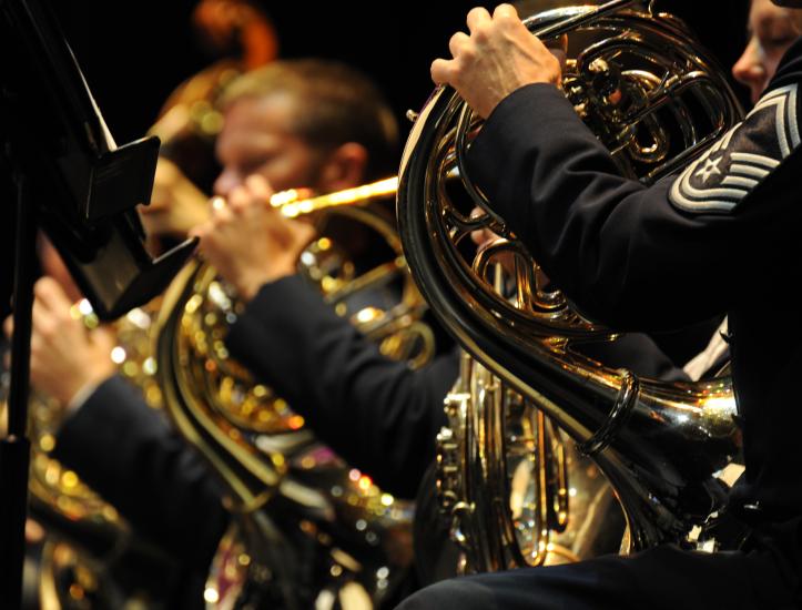 Two people playing brass instruments as part of a concert band.