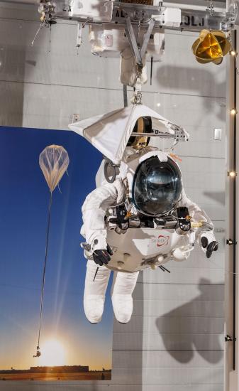 Front view of Alan Eustace's white freefall jumpsuit hanging on display in the Museum