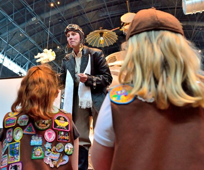 Costumed character talks to girls at family day event