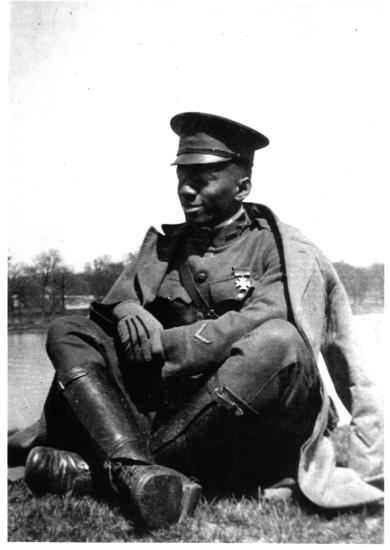 William J. Powell, a black man, sits while wearing his Army uniform.