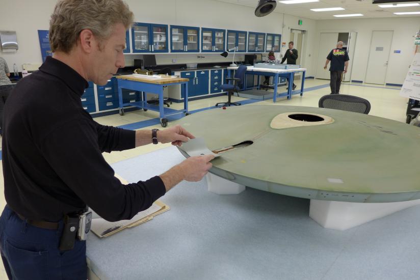 A Museum conservation specialist tries to find the correct paint color for a gray spaceship studio model used in the television series Star Trek