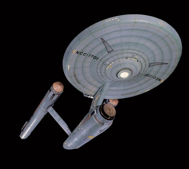 A studio model of the Starship Enterprise, a ship used in the Star Trek franchise with a saucer, two warp drives, and a cargo bay