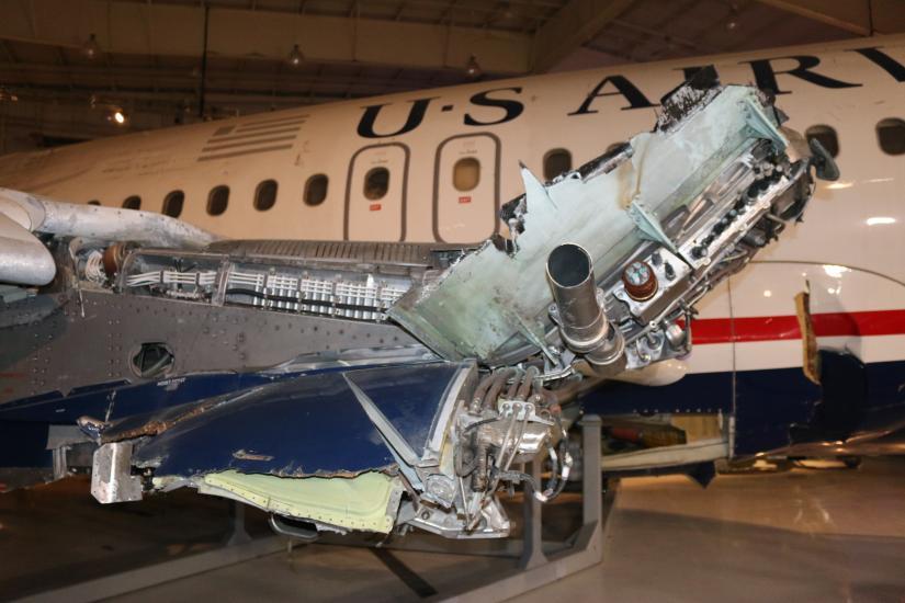 View of a damaged wing where an engine is missing. 