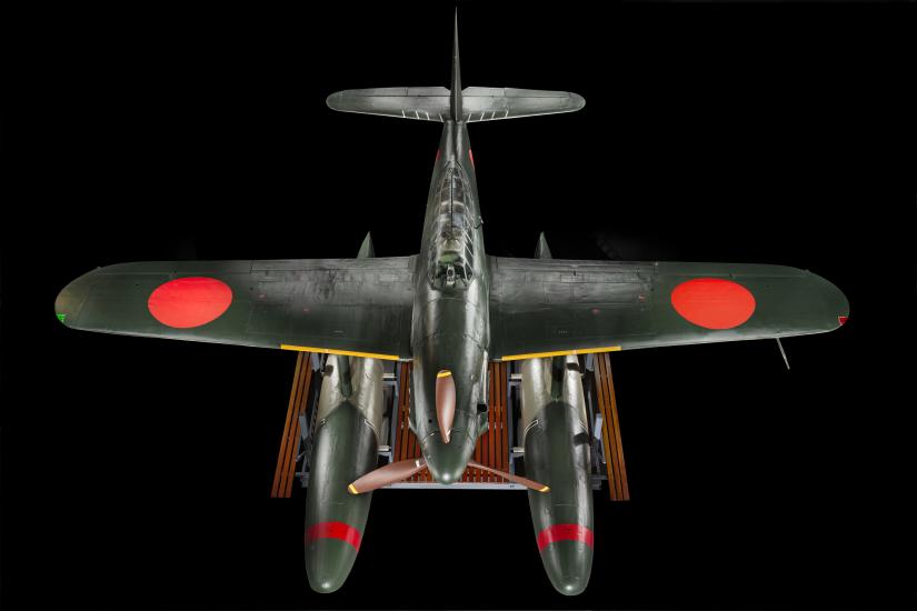 View from top of green bomber with red roundels on the wings and twin floats in place of wheels