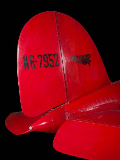 Tail of red Amelia Earhart Lockheed Vega 5B aircraft with "NR-7952" and lockheed logo in black