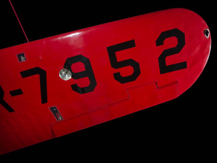 Under wing of red Amelia Earhart Lockheed Vega 5B aircraft with "7952" in black letters