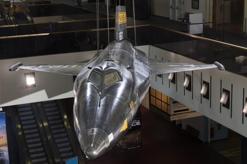 Tip of black titanium rocket-shaped North American x-15 aircraft hanging in museum