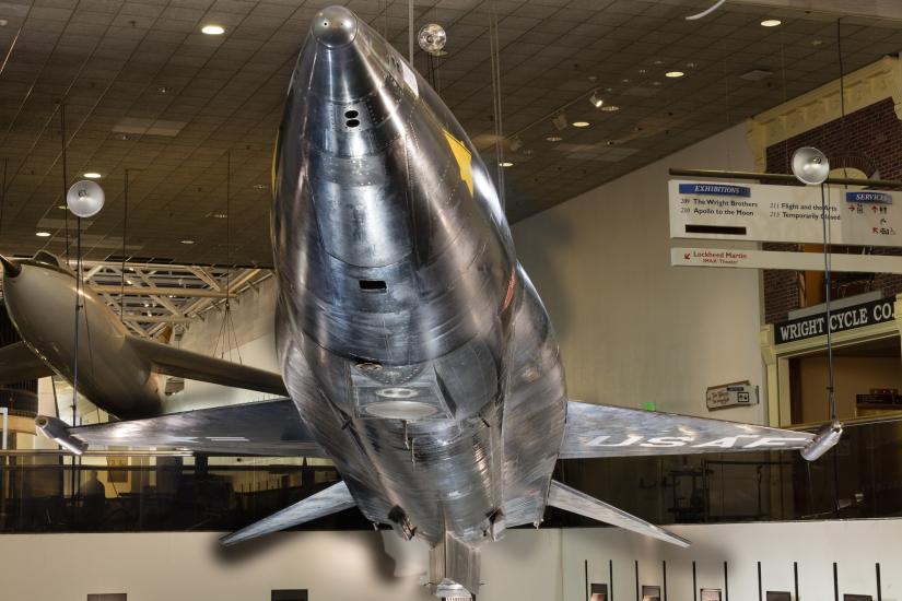 Tip of black titanium rocket-shaped North American x-15 aircraft hanging in museum