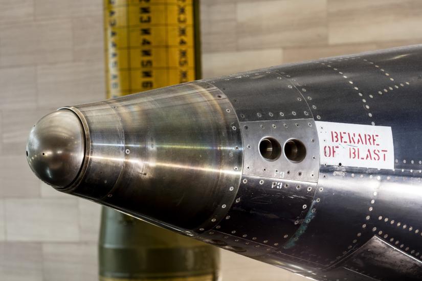 Two circlular indentations on side of rounded nose of black titanium North American x-15 aircraft