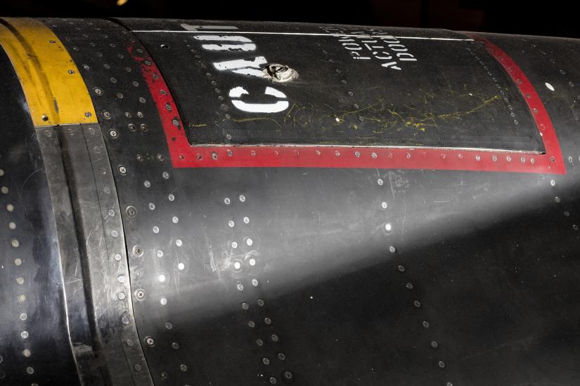 Red square outline and "Caution" in white lettering on black titanium North American x-15 aircraft