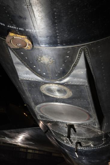 Circular metal plates and apparatuses on bottom of North American x-15 aircraft